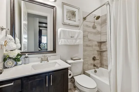 a bathroom with a sink toilet and shower