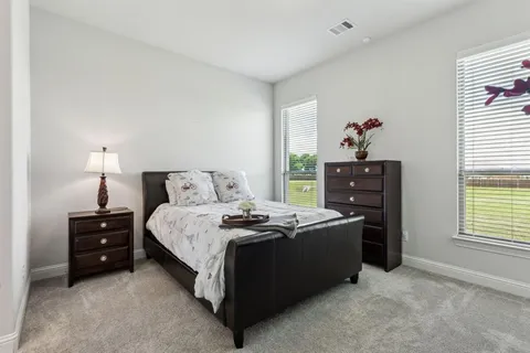 a bed room with a bed and a window