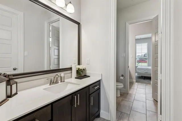 a en suite bathroom with a sink double vanity and a mirror