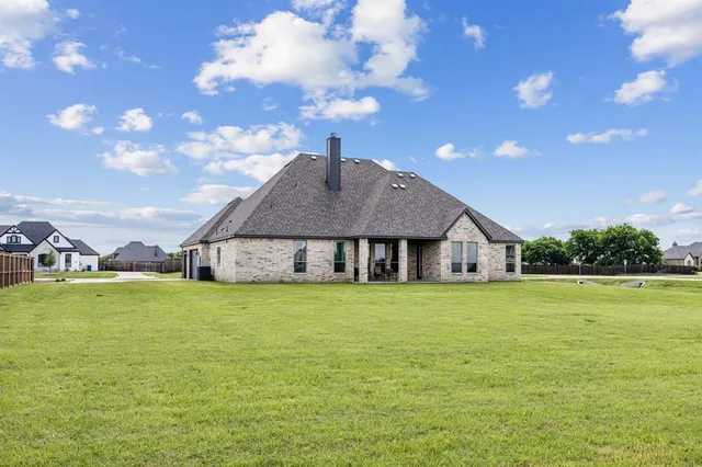 a big house with a big yard and large trees