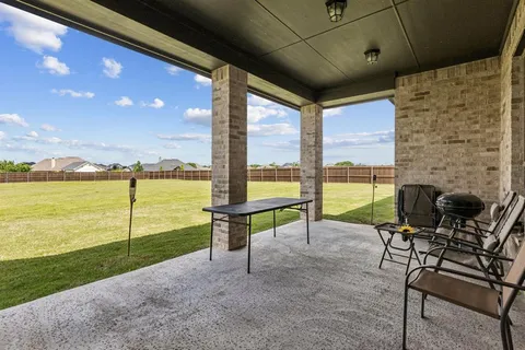 a view of a terrace with chairs and ocean view