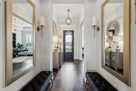 a view of a hallway view with wooden floor and furniture