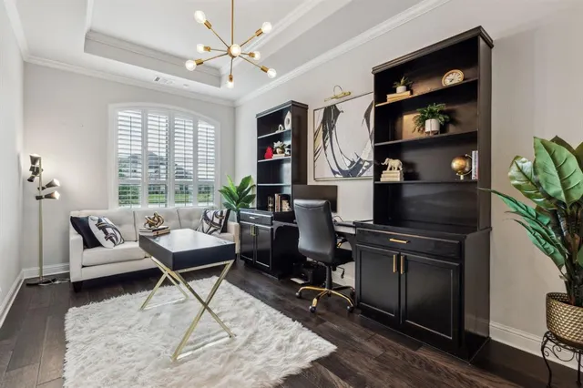 a view of a workspace with furniture and a window