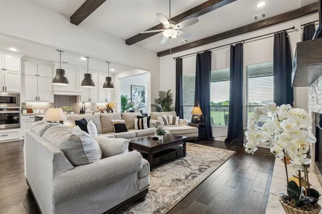 a living room with furniture fireplace and a large window