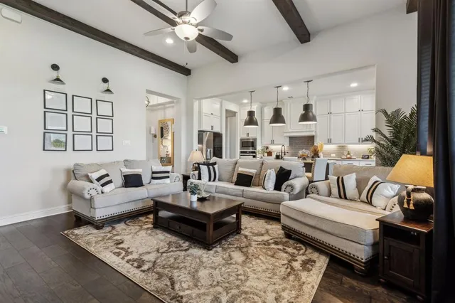 a living room with furniture ceiling fan and a rug