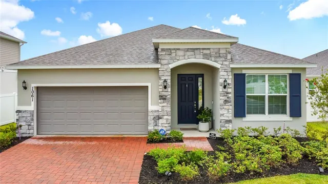 a front view of a house with a yard and garage