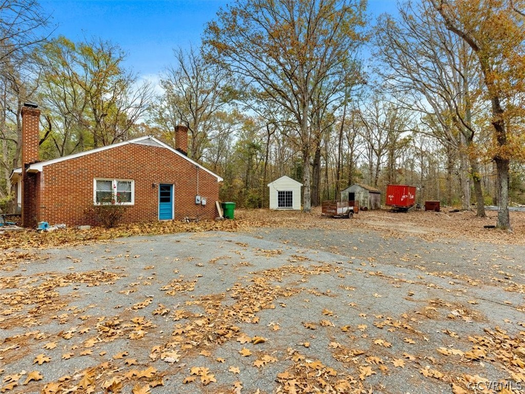 8343 Hull Street Road North Chesterfield, VA 23235 - Photo 6 of 7 a house with trees in front of it