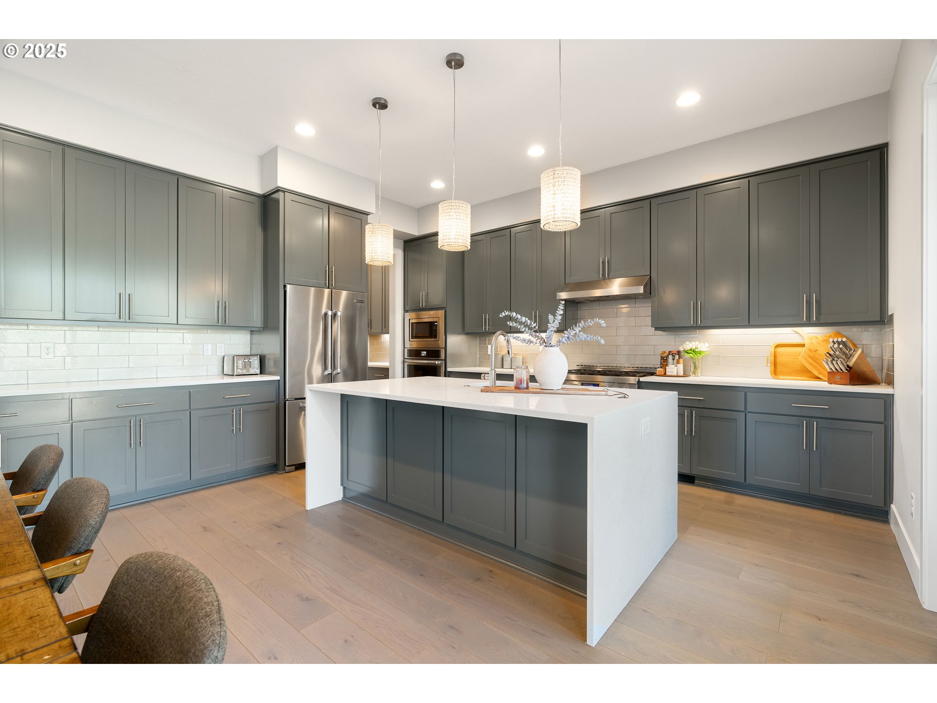 10805 Northwest Cornell Road Portland, OR 97229 - Photo 11 of 39 a kitchen with kitchen island granite countertop a sink cabinets and stainless steel appliances