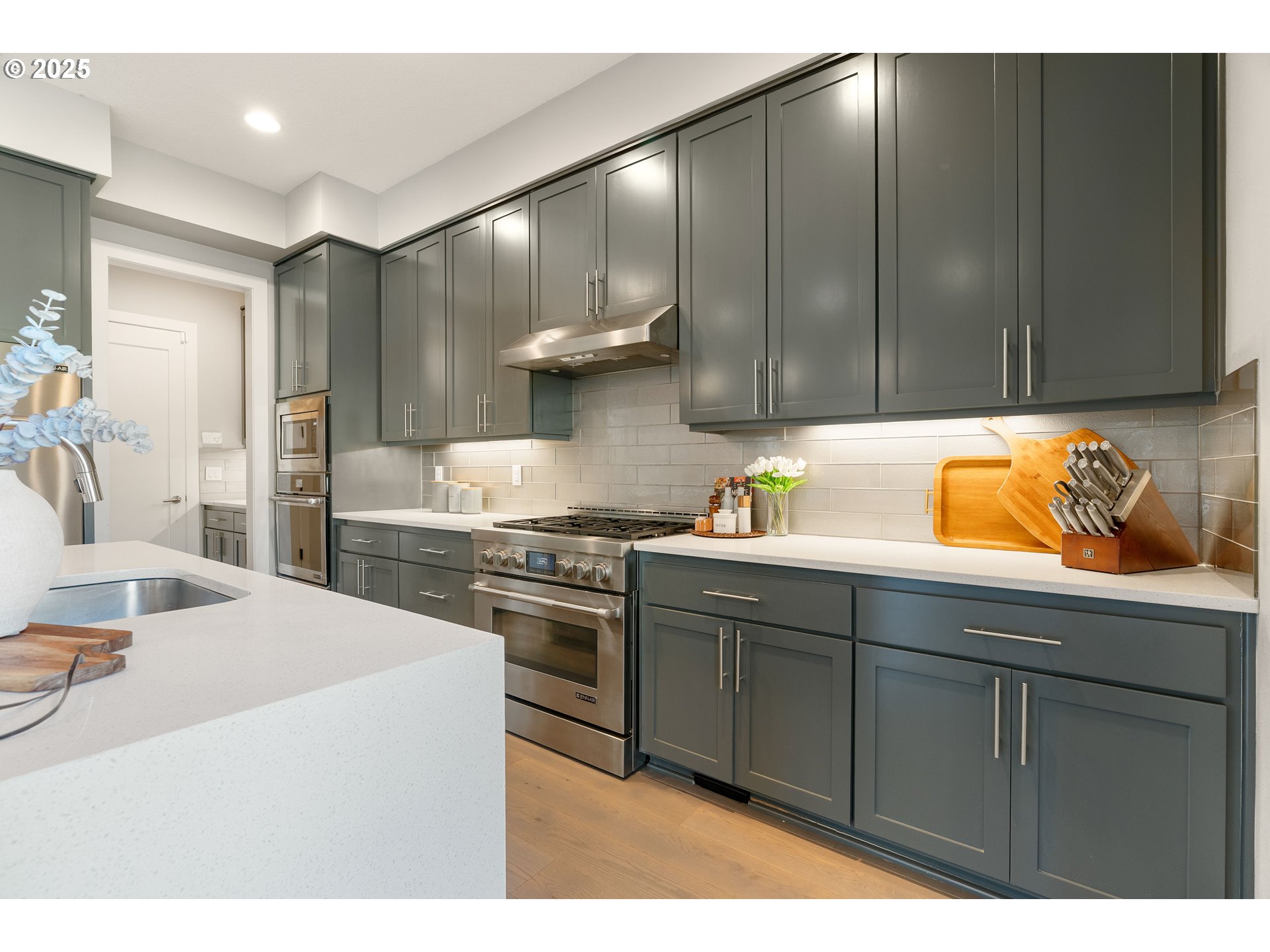 10805 Northwest Cornell Road Portland, OR 97229 - Photo 12 of 39 a kitchen with stainless steel appliances granite countertop a sink stove and cabinets
