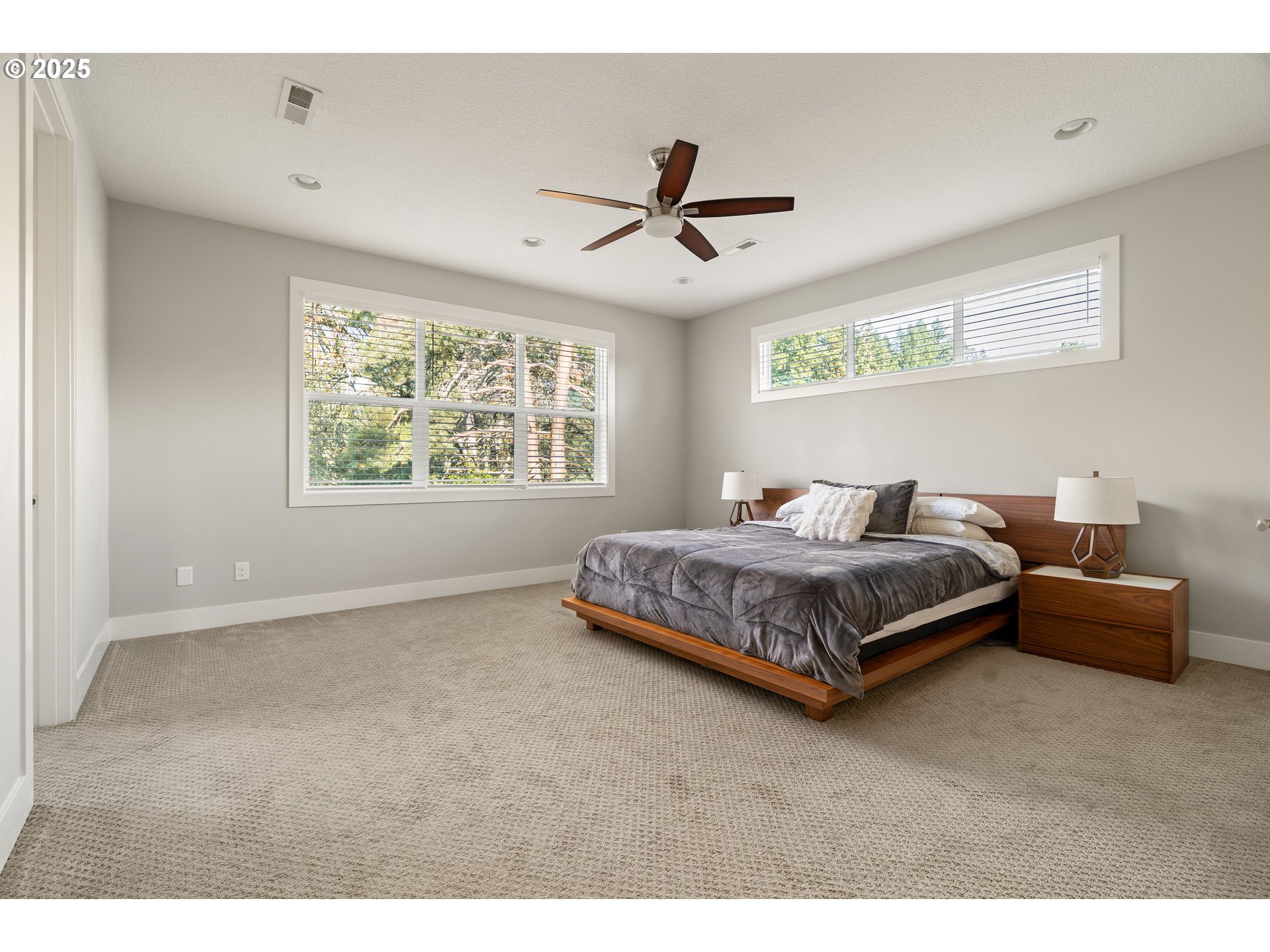10805 Northwest Cornell Road Portland, OR 97229 - Photo 25 of 39 a bedroom with a bed and a chandelier