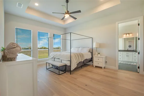 a bedroom with a bed and large window