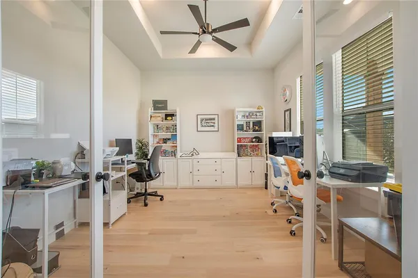 a view of a livingroom with workspace and a window
