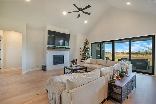a living room with furniture fireplace and a large window