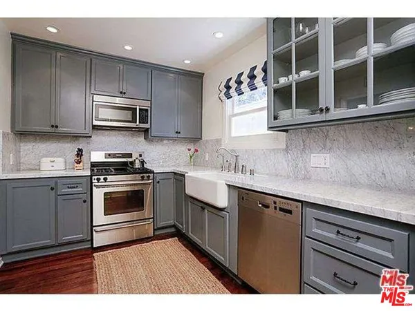 a kitchen with stainless steel appliances granite countertop a sink and cabinets
