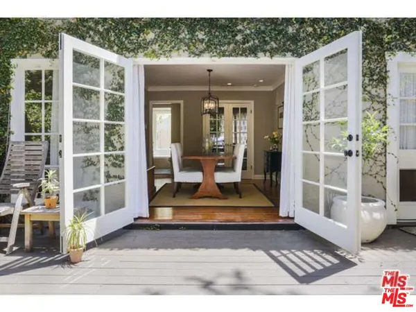 a backyard of a house with table and chairs