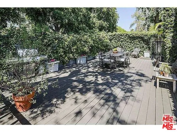 a view of a chairs and table in patio