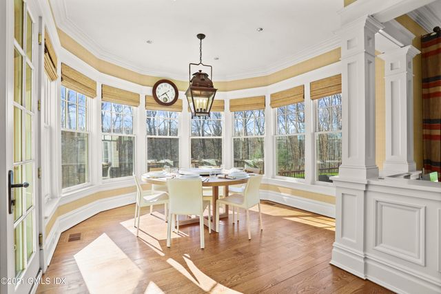 a view of a dining room with furniture wooden floor and a chandelier