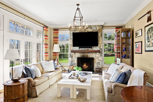 a living room with furniture a flat screen tv and a fireplace