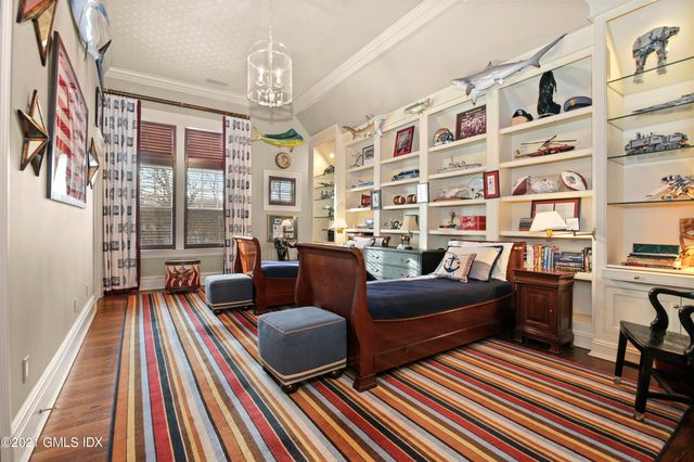 a living room with furniture a bookshelf and a chandelier