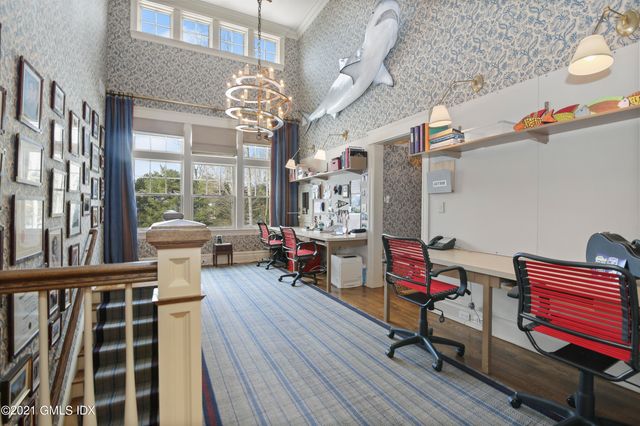 a living room with furniture a chandelier and a dining table