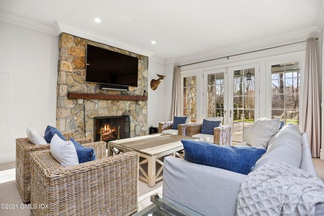 a living room with furniture fireplace and a flat screen tv