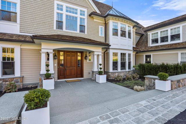 a view of a brick building with potted plants in front of door