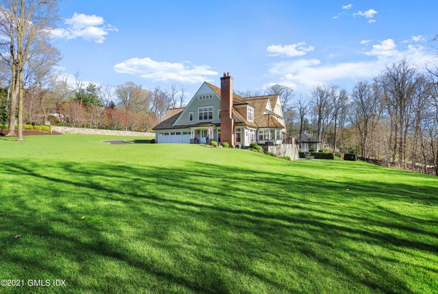 a view of a big yard with a house in the background