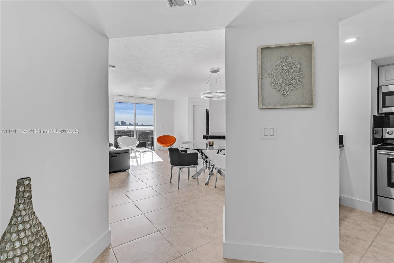 5880 Collins Avenue, Unit PH3 Miami Beach, FL 33140 - Photo 15 of 34 a living room with furniture a couch and a dining table