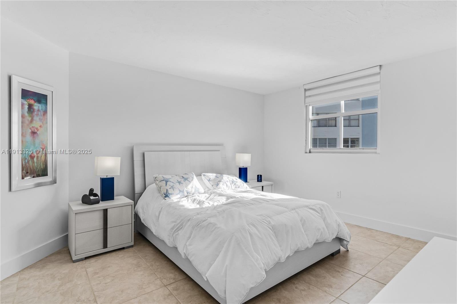 5880 Collins Avenue, Unit PH3 Miami Beach, FL 33140 - Photo 24 of 34 a bedroom with a bed and a night stand