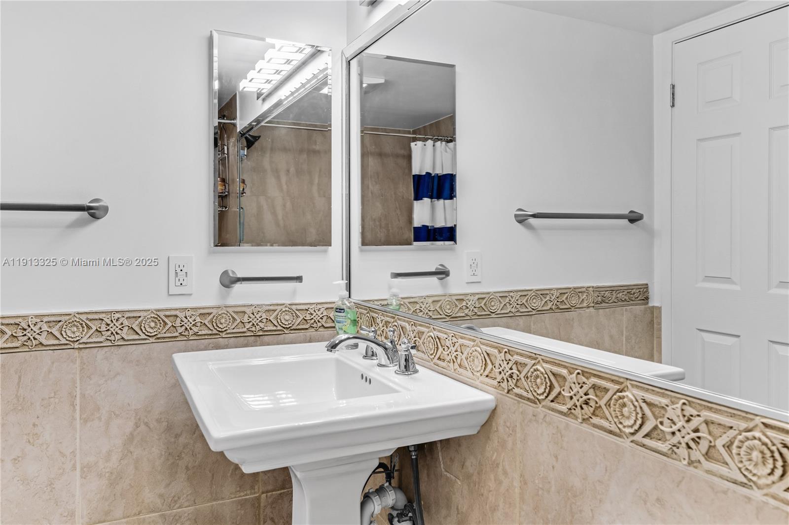 5880 Collins Avenue, Unit PH3 Miami Beach, FL 33140 - Photo 29 of 34 a bathroom with a sink and a mirror