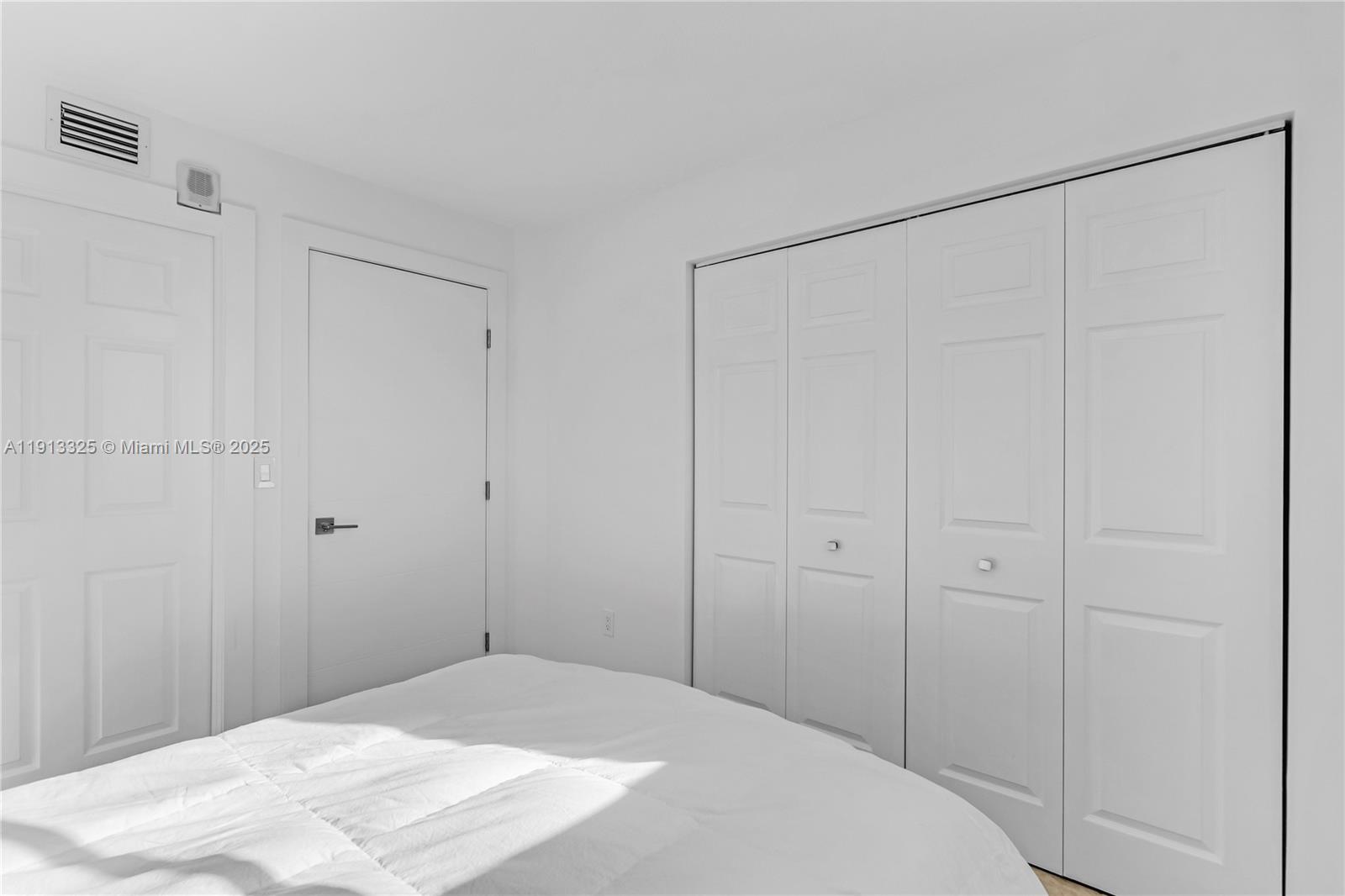 5880 Collins Avenue, Unit PH3 Miami Beach, FL 33140 - Photo 31 of 34 a bedroom with a white bed and a shower