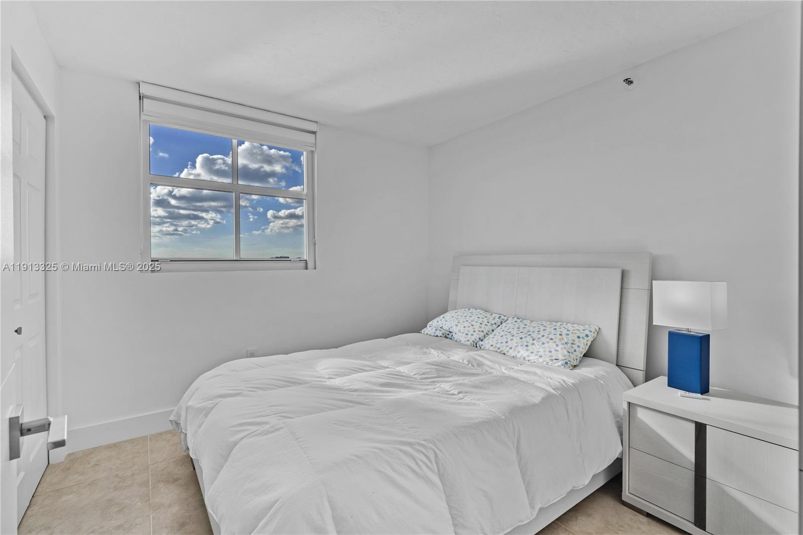 5880 Collins Avenue, Unit PH3 Miami Beach, FL 33140 - Photo 32 of 34 a bedroom with a bed and a painting on the wall