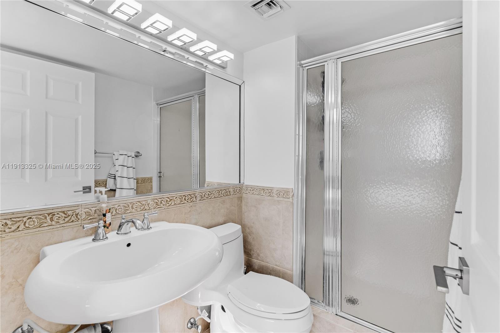 5880 Collins Avenue, Unit PH3 Miami Beach, FL 33140 - Photo 33 of 34 a bathroom with a sink toilet and shower