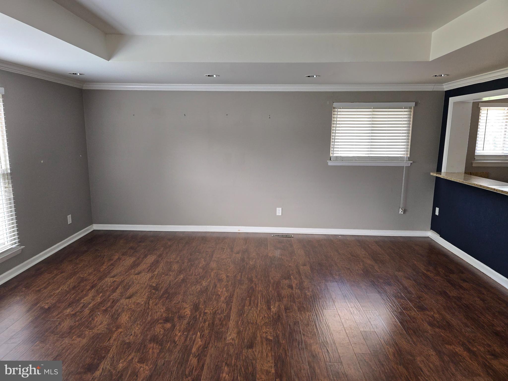 8343 Scotts Level Road Pikesville, MD 21208 - Photo 11 of 33 a view of an empty room with wooden floor and a window