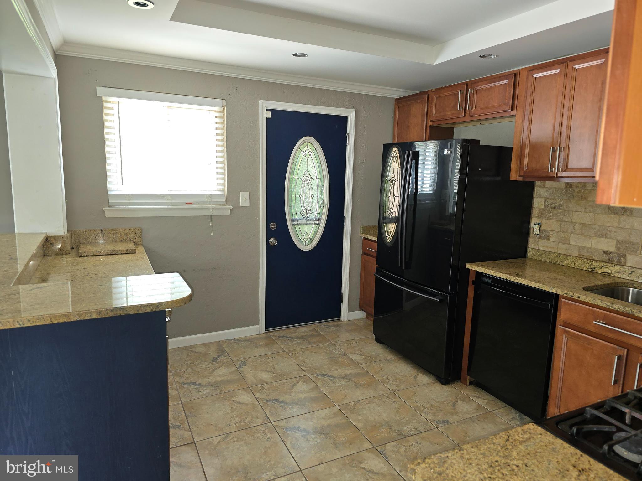 8343 Scotts Level Road Pikesville, MD 21208 - Photo 13 of 33 a kitchen with stainless steel appliances granite countertop a stove a refrigerator and a sink