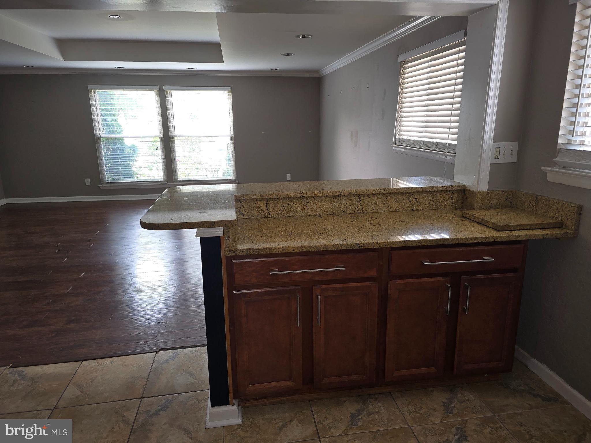 8343 Scotts Level Road Pikesville, MD 21208 - Photo 17 of 33 a kitchen with kitchen island a sink window and cabinets