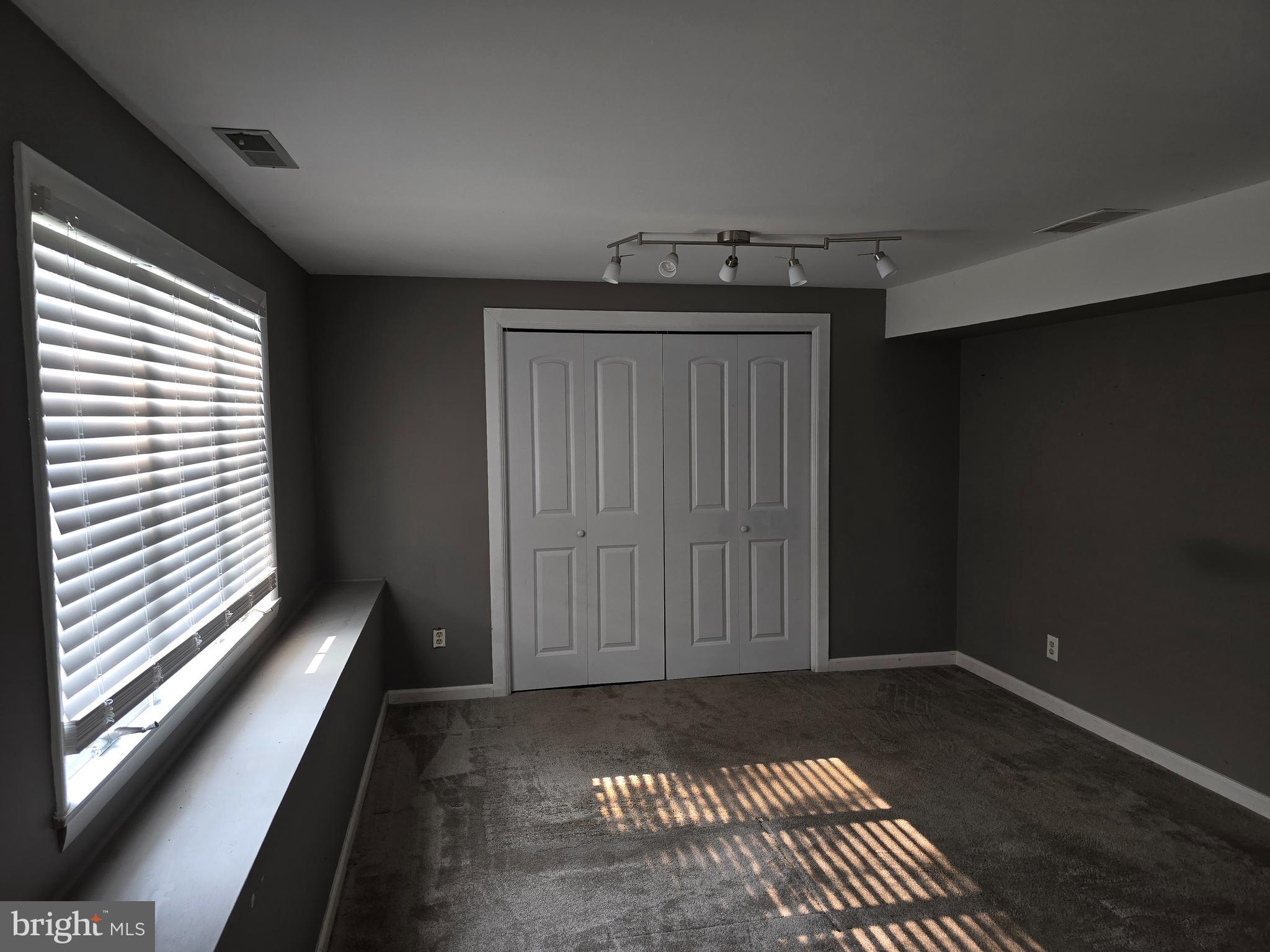 8343 Scotts Level Road Pikesville, MD 21208 - Photo 21 of 33 a view of a room with wooden floor and windows
