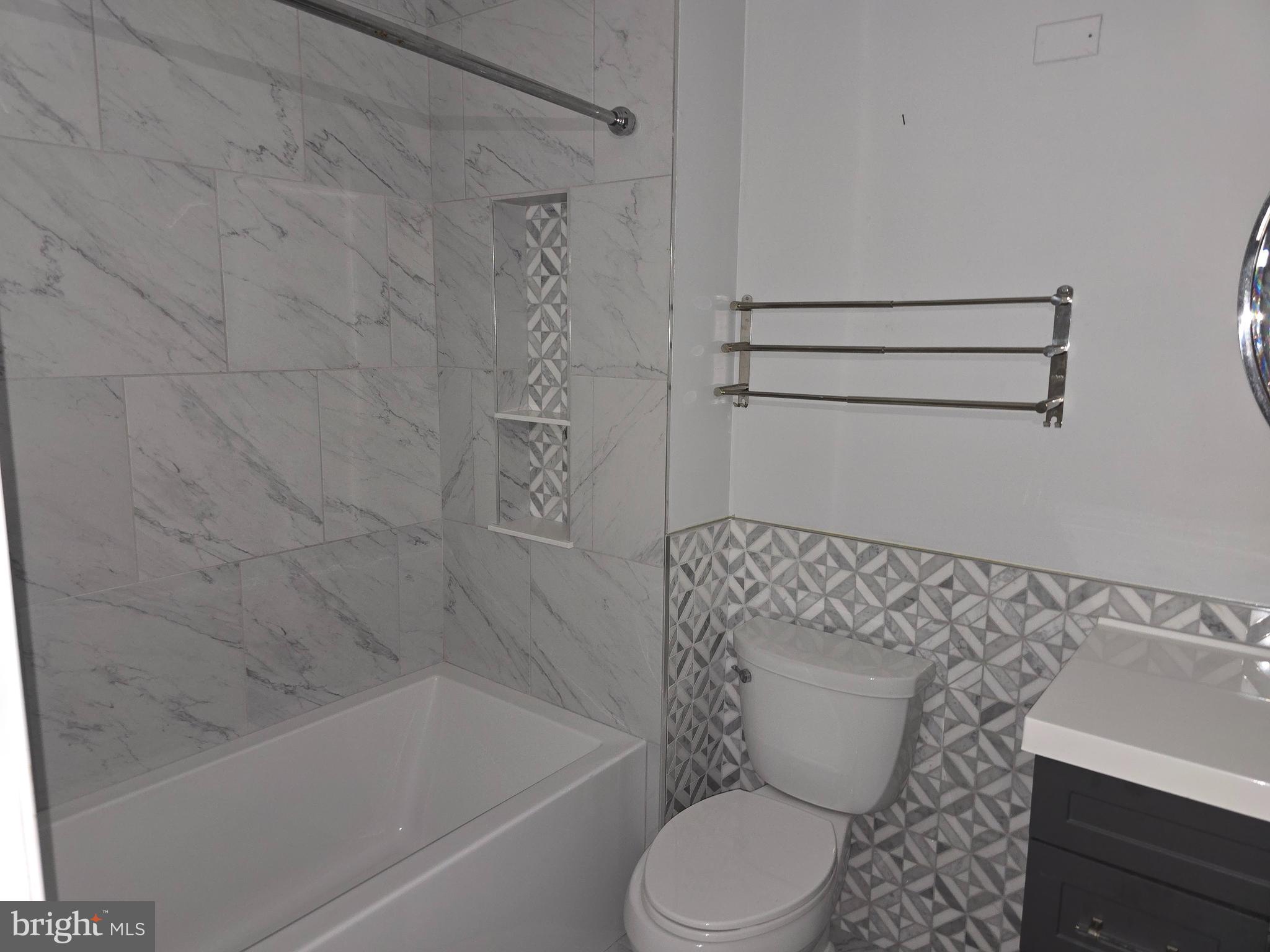 8343 Scotts Level Road Pikesville, MD 21208 - Photo 24 of 33 a bathroom with a toilet and a bathtub