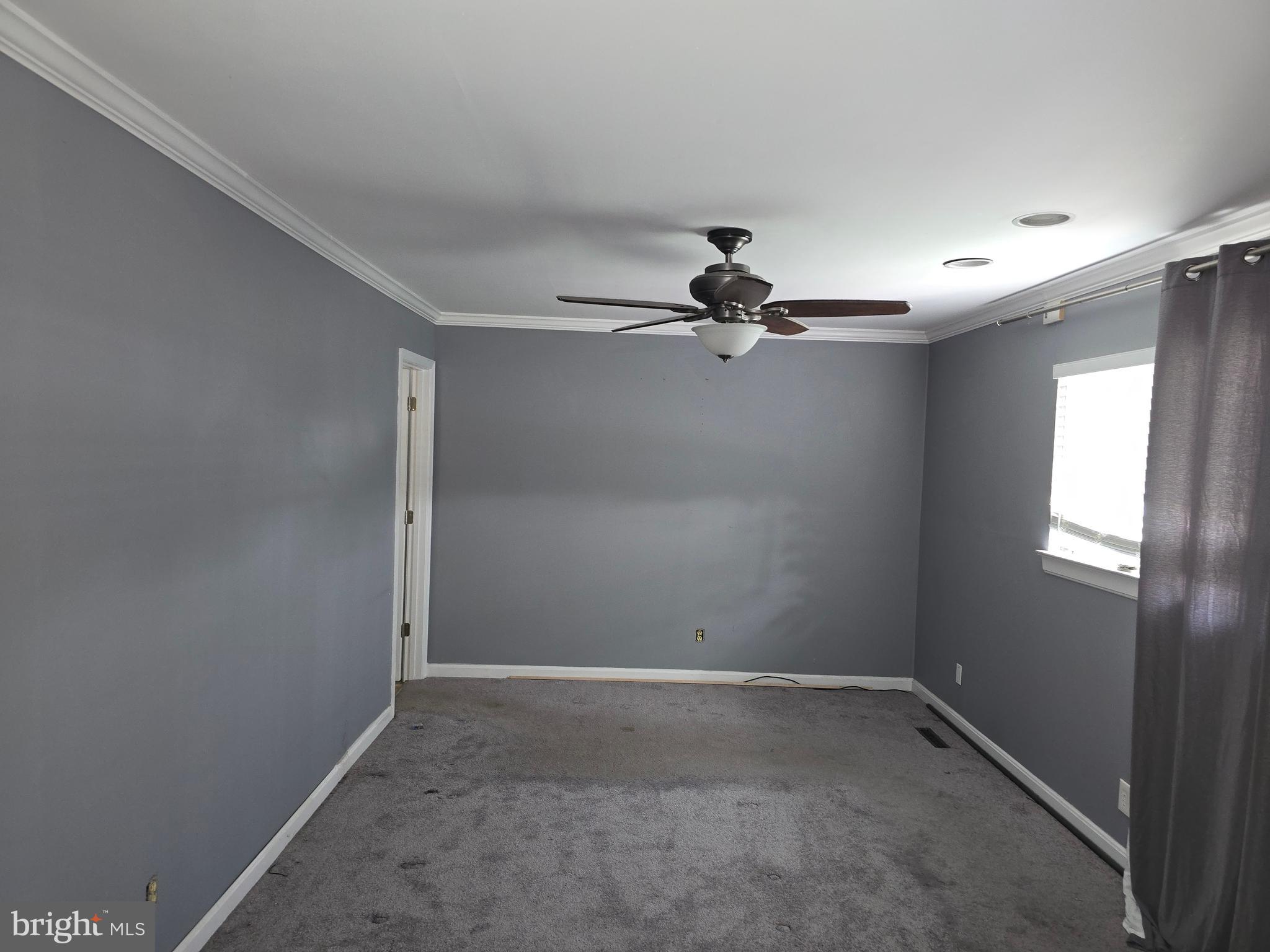 8343 Scotts Level Road Pikesville, MD 21208 - Photo 26 of 33 a view of a room with a ceiling fan and window