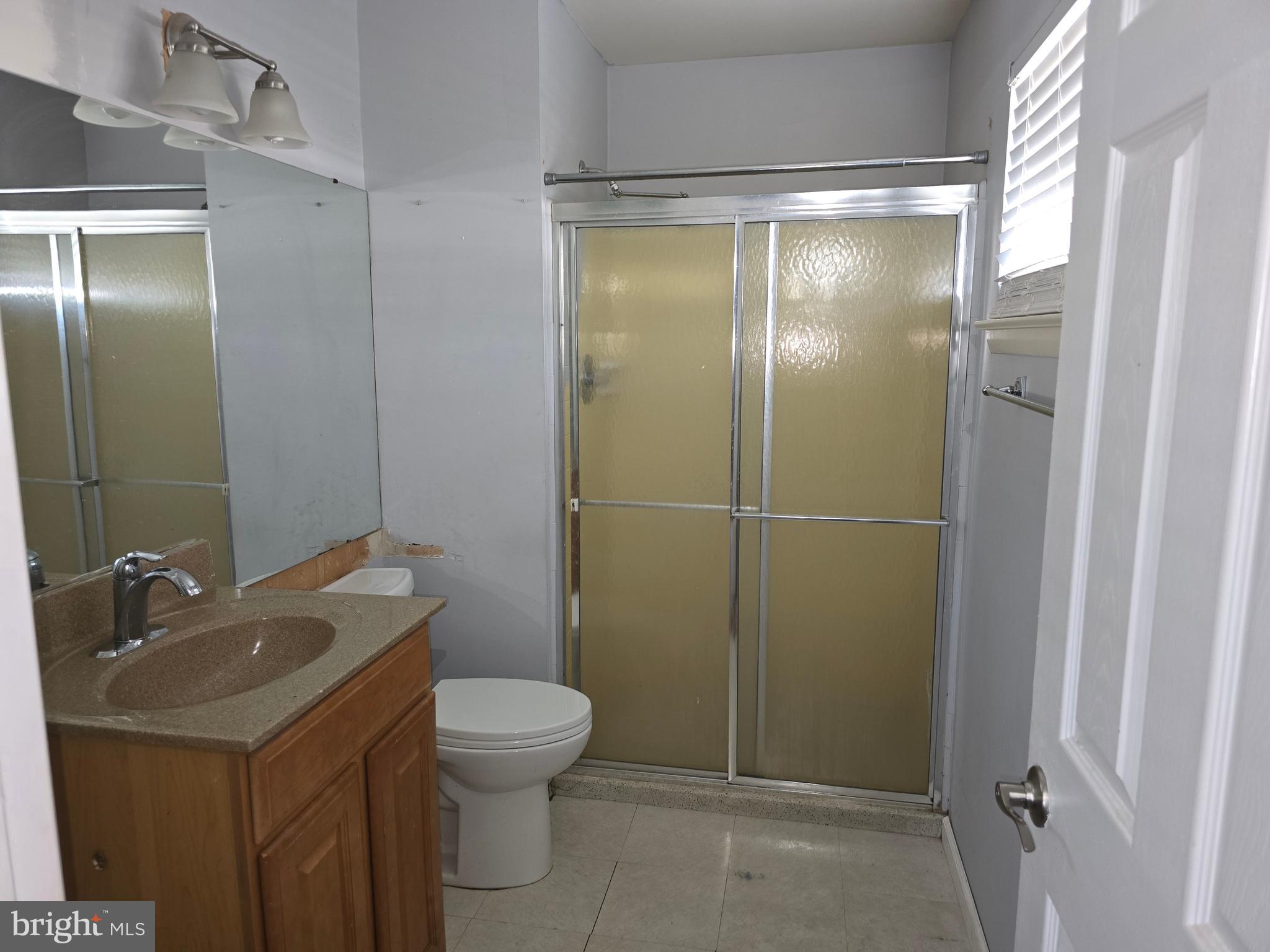 8343 Scotts Level Road Pikesville, MD 21208 - Photo 28 of 33 a bathroom with a sink a toilet and shower