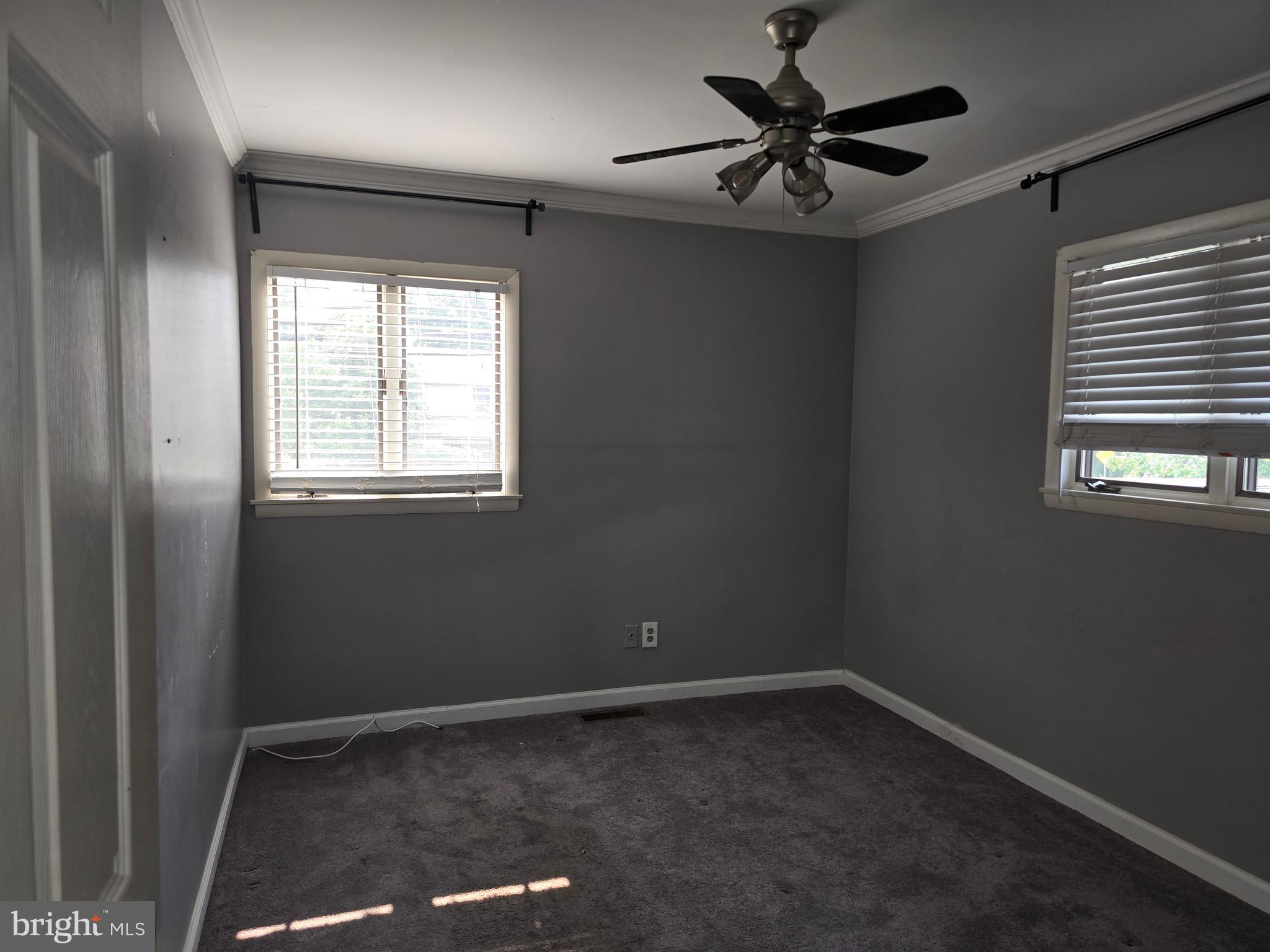 8343 Scotts Level Road Pikesville, MD 21208 - Photo 29 of 33 a view of a livingroom with a ceiling fan and window
