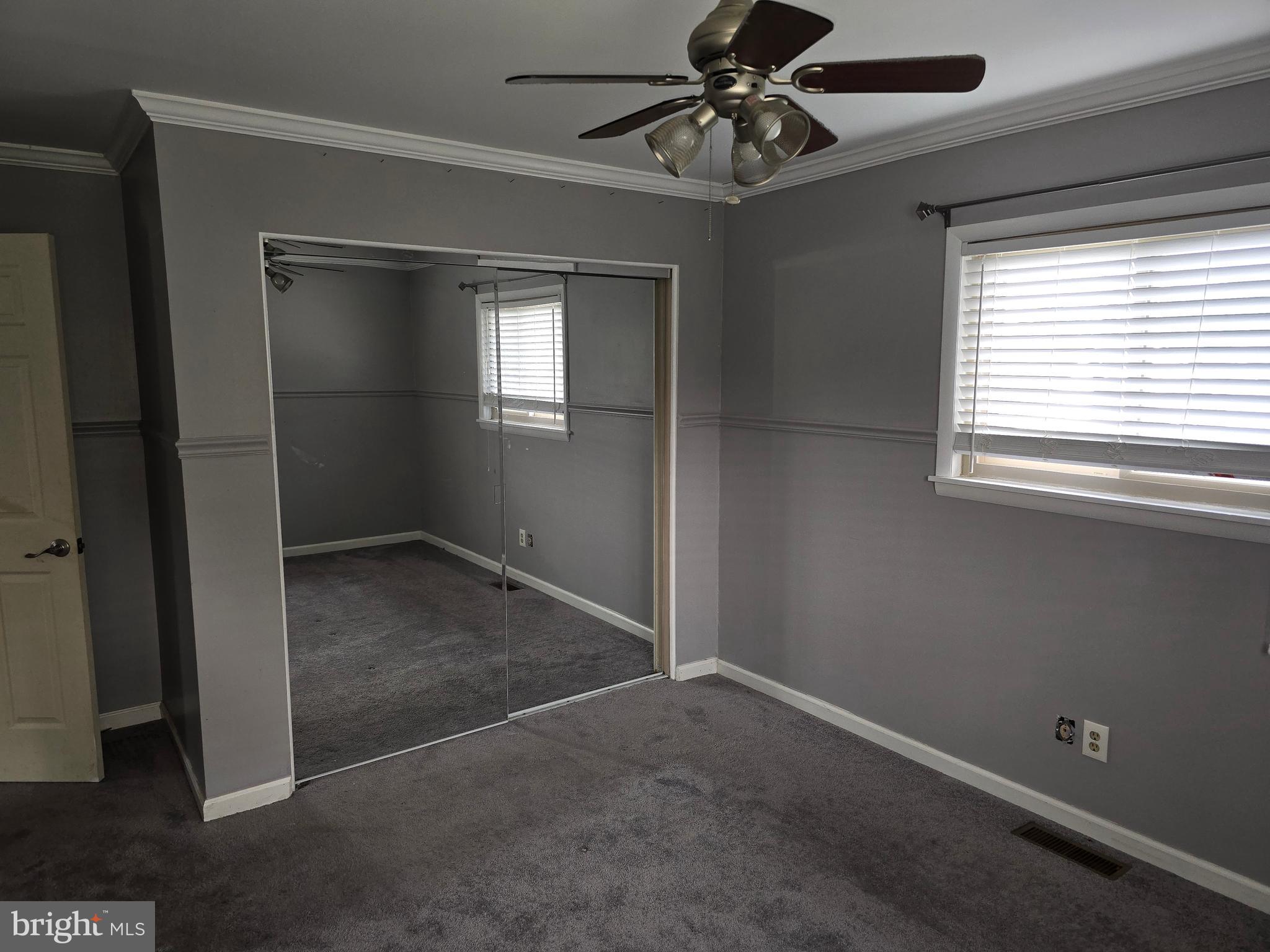 8343 Scotts Level Road Pikesville, MD 21208 - Photo 32 of 33 an empty room with windows and fan
