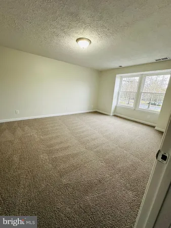 a view of an empty room and a window