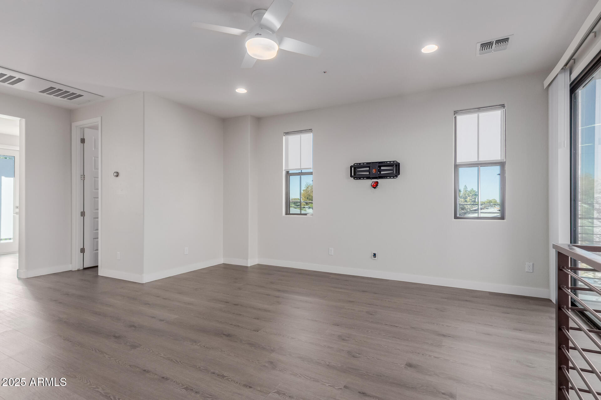 4235 North 26th Street, Unit 1 Phoenix, AZ 85016 - Photo 8 of 62 a view of an empty room with wooden floor and a window