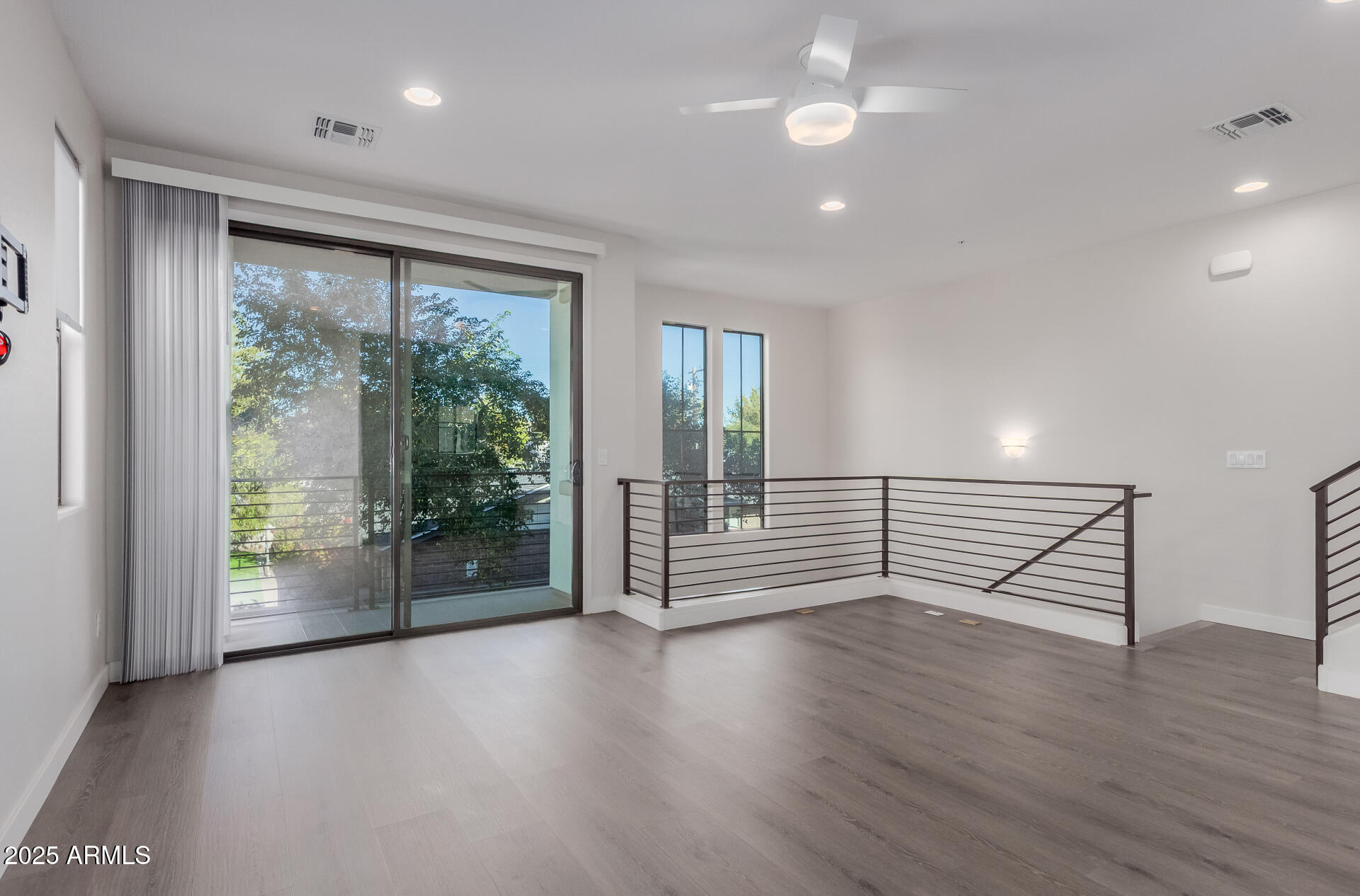 4235 North 26th Street, Unit 1 Phoenix, AZ 85016 - Photo 9 of 62 an empty room with wooden floor and windows