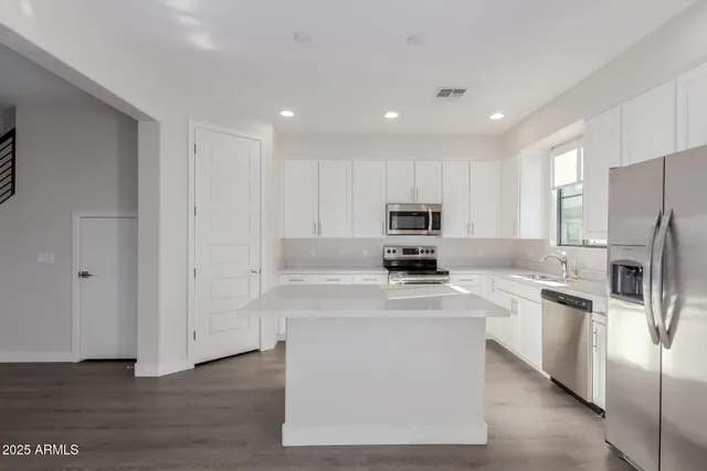 a view of a room with wooden floor and window