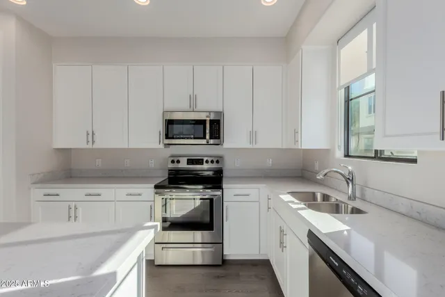 a view of a kitchen with wooden floor and a sink