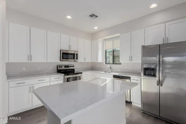 a kitchen with cabinets and stainless steel appliances