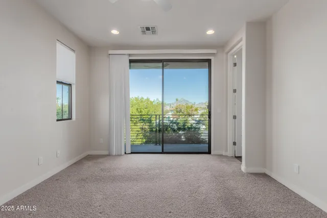 a view of an empty room with glass door