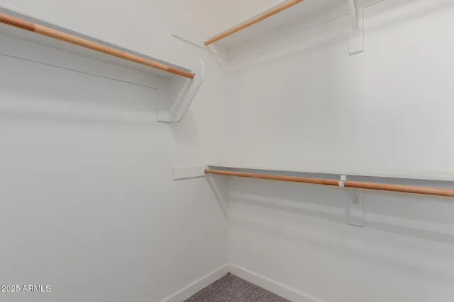 a bathroom with double sink and a mirror